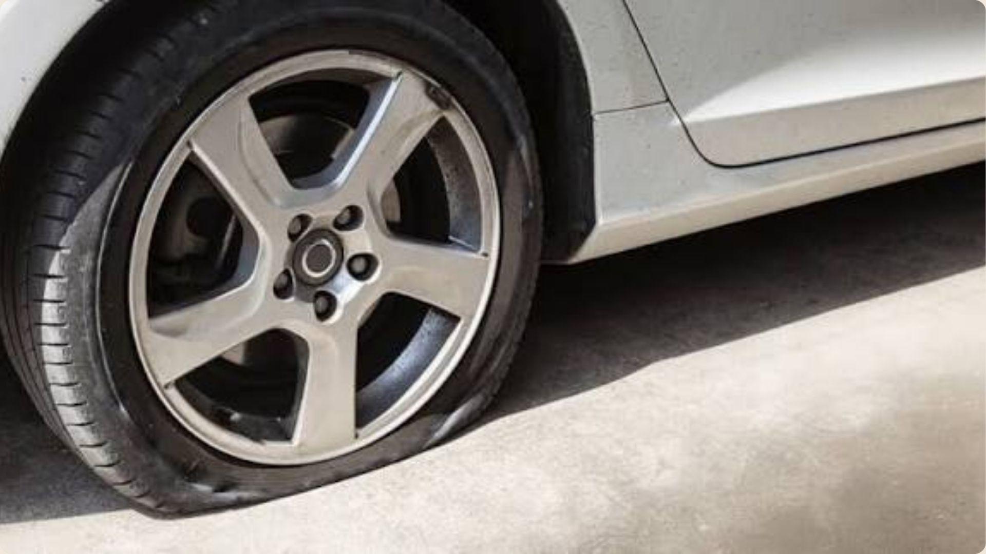 Close-up view of a car tire showcasing flat tire.