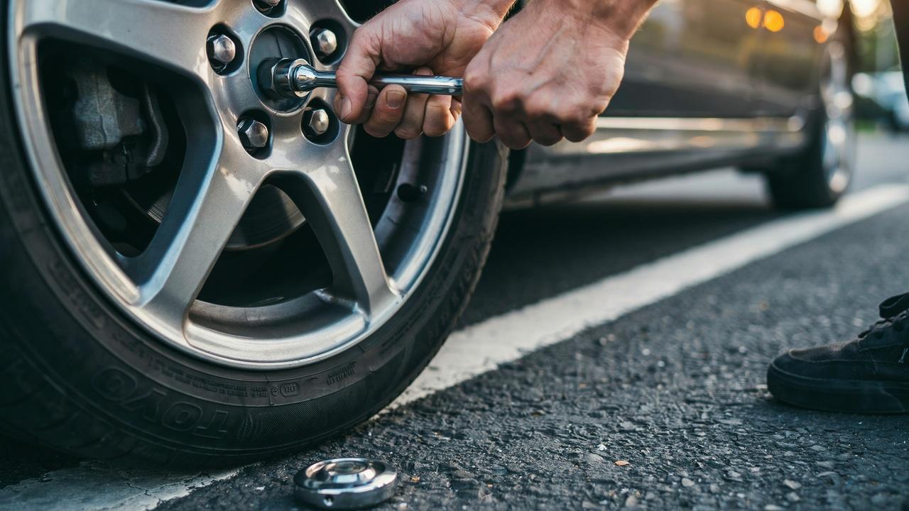 Loosening lug nuts after removing hubcap.