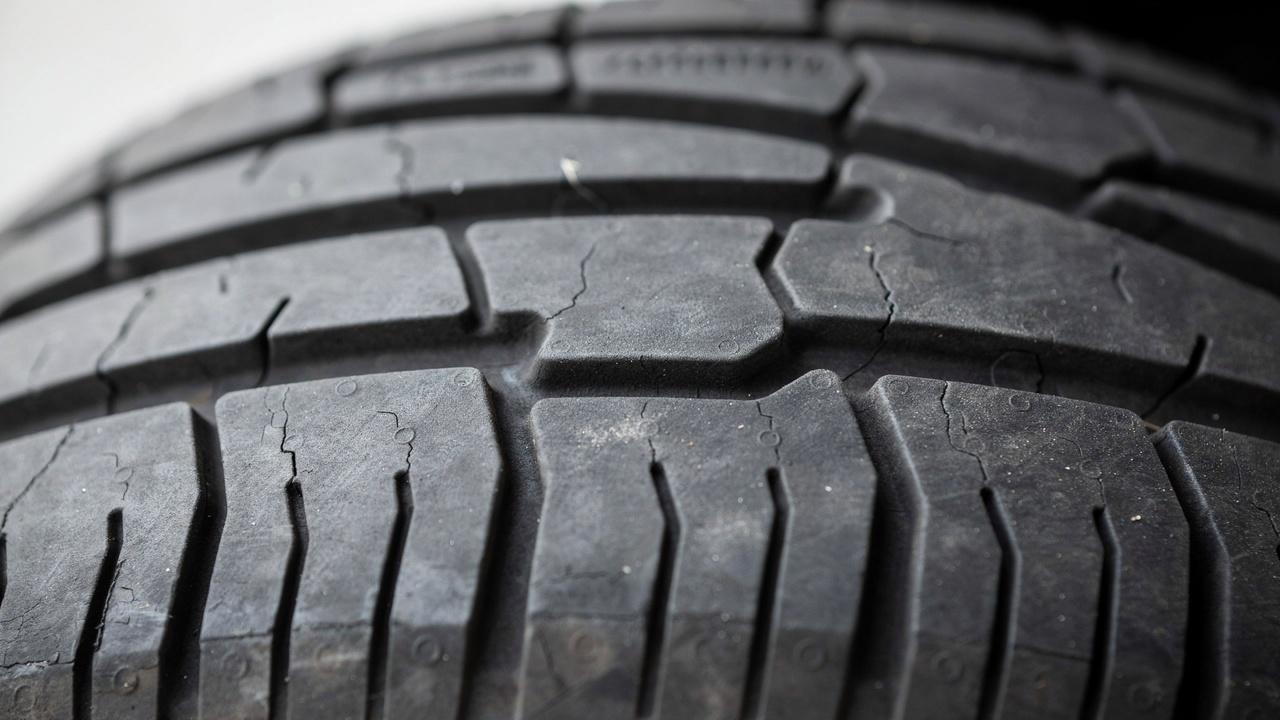 Tire tread wear indicators showing worn tread.