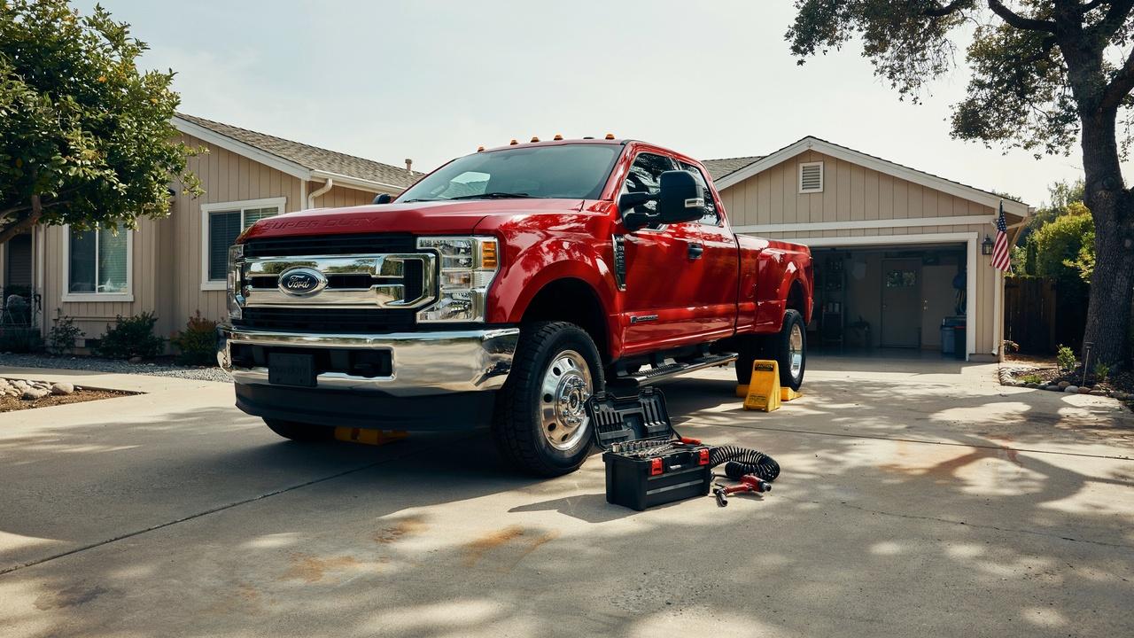 Dually truck safely parked on level ground before tire rotation.